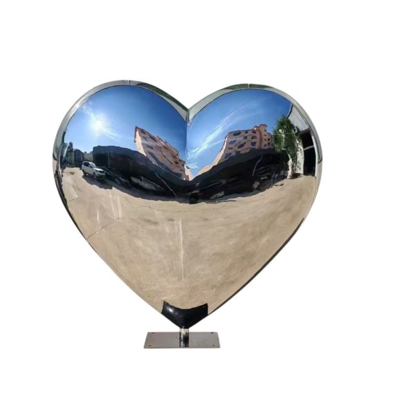 Heart-shaped mirror polished stainless steel sculpture placed outdoors