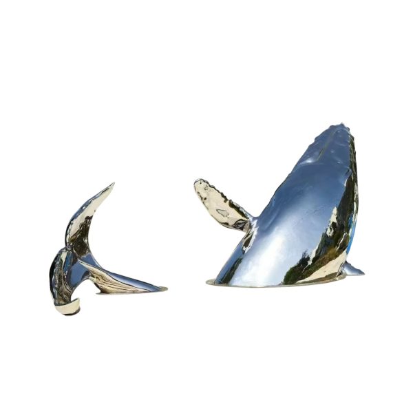 Stainless steel whale sculpture breaching from the ocean – outdoor public art