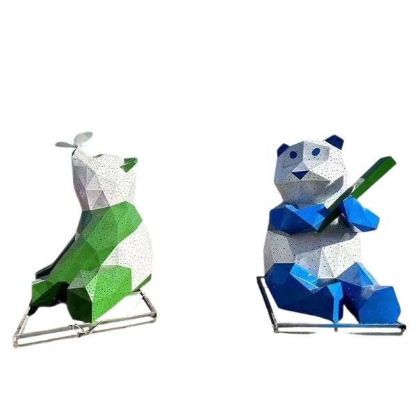 Blue and white geometric panda sculpture holding bamboo for outdoor display.