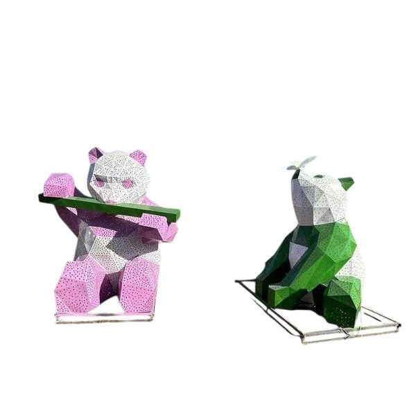 Blue and white geometric panda sculpture holding bamboo for outdoor display.