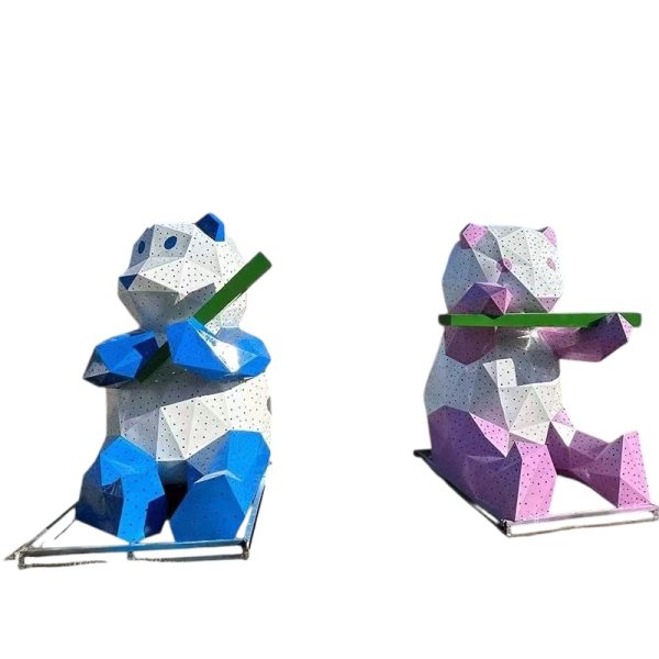 Blue and white geometric panda sculpture holding bamboo for outdoor display.