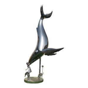 A stainless steel sculpture of a whale interacting with a little girl, polished to a mirror finish, suitable for outdoor display.