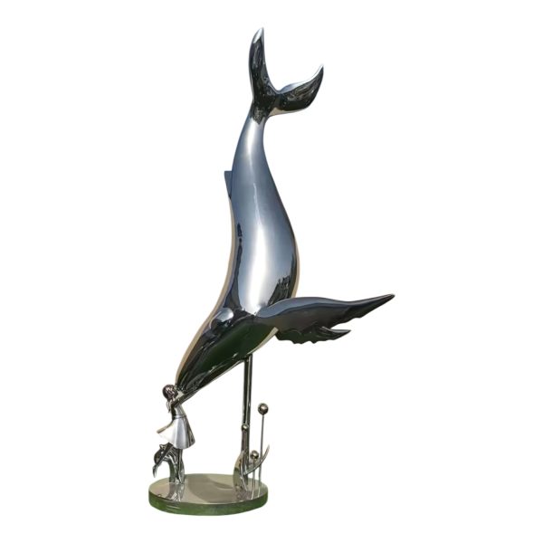 A stainless steel sculpture of a whale interacting with a little girl, polished to a mirror finish, suitable for outdoor display.