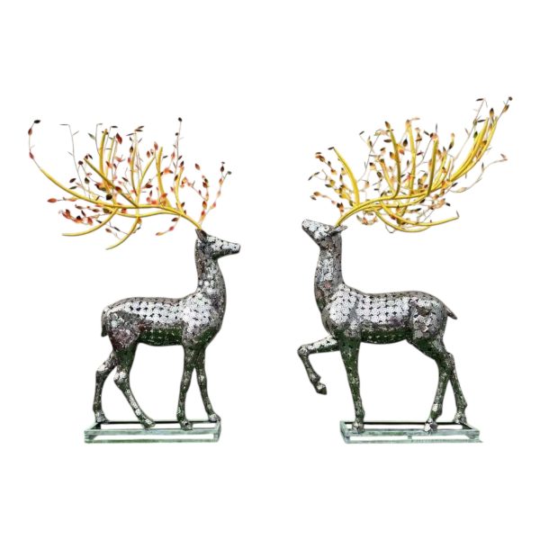 Pair of stainless steel deer sculptures with decorative golden antlers for outdoor display.