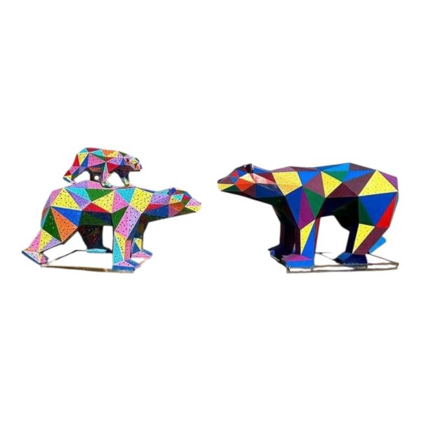 Colorful geometric stainless steel polar bear sculpture with polygonal surfaces.