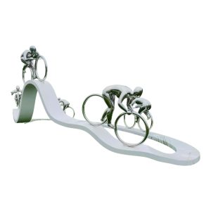 Stainless steel sculpture of cyclists riding on a curved track, symbolizing speed and motion.