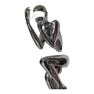 Contemporary stainless steel figure sculpture with reflective finish, designed for art installations.